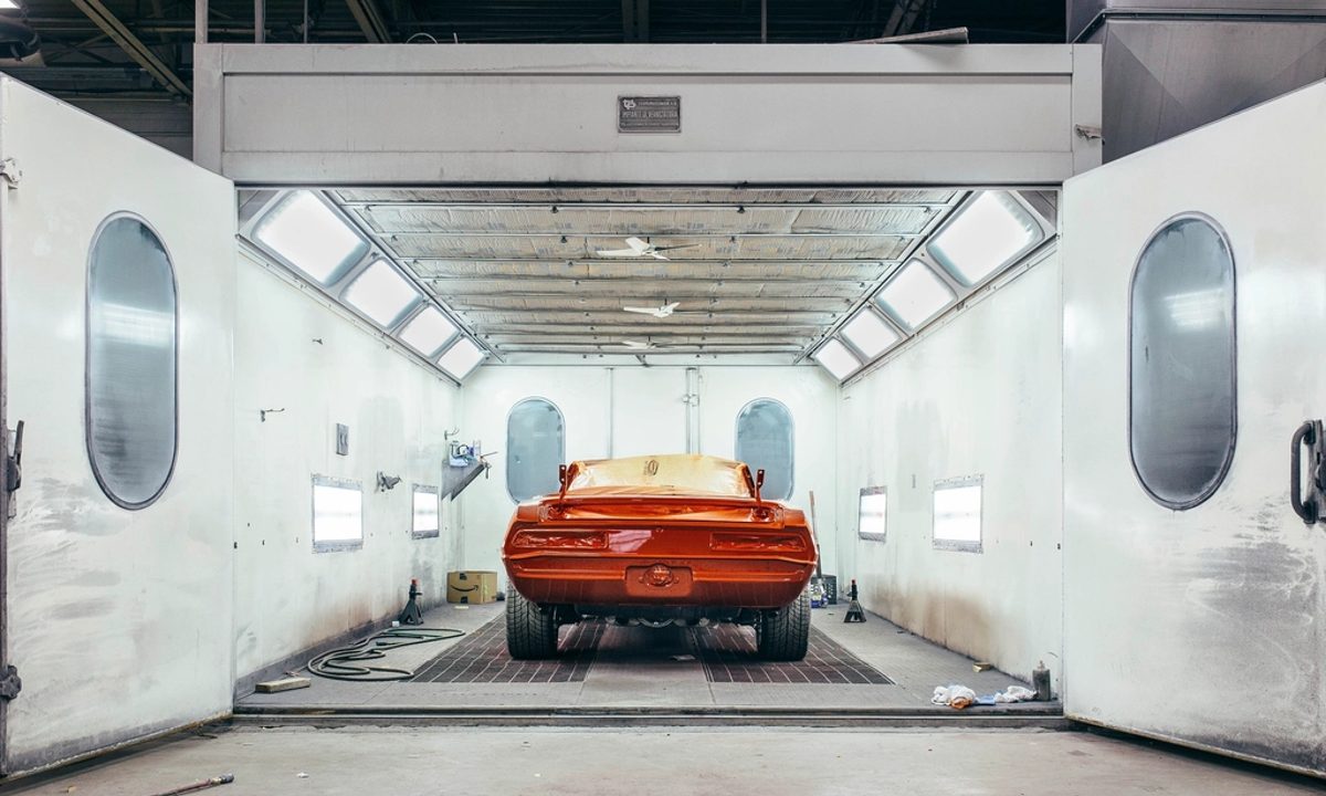 Car body inside an automotive paint and finishing booth