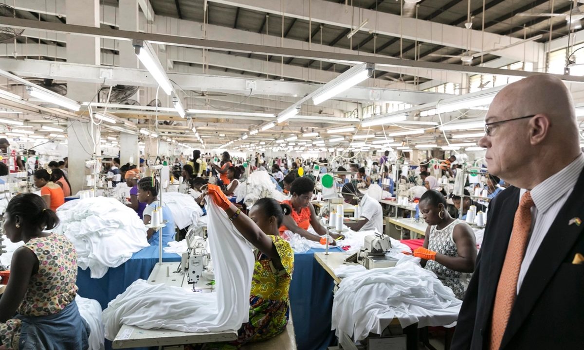 Garment factory floor with workers at sewing stations